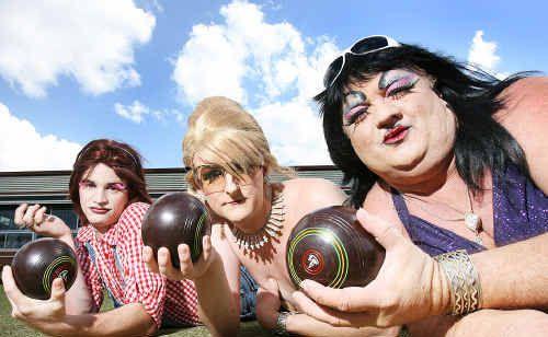 Drag queens holding balls on the lawn bowl court